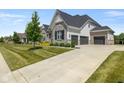 Elegant home with a three-car garage, spacious driveway, and well-kept lawn at 2566 Maple Creek Dr, Westfield, IN 46074
