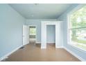 Bedroom with hardwood floors, built-in closet, and a large window at 2627 Chase St, Anderson, IN 46016