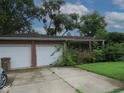 Charming brick home with a two-car garage and ample driveway space at 3103 Westenedge Dr, Columbus, IN 47203