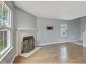 Spacious living room boasts a fireplace, large windows, and an area ready for wall mounted TV at 5541 Lippan Way, Indianapolis, IN 46221