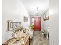 Bright foyer showcasing tile floors, a chandelier, and charming decor at 5865 Pennekamp Dr, Plainfield, IN 46168