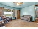 Cozy living room with neutral carpet, ceiling fan and view to the front yard at 6349 S Harding St, Indianapolis, IN 46217