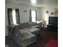 Open living room features a large sectional couch and natural light from the window at 8256 Meadowlark Dr, Indianapolis, IN 46226