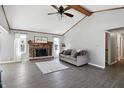 Bright living room featuring a fireplace, ceiling fan, and vaulted ceilings at 1011 Stevedon Ct, Plainfield, IN 46168