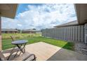 Relaxing back patio with outdoor seating, perfect for enjoying the serene backyard view at 114 Asbury Dr, Anderson, IN 46013