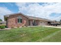 Attractive brick house with a well-kept lawn, a two-car garage, and a welcoming curb appeal at 114 Asbury Dr, Anderson, IN 46013