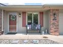 Cozy front porch featuring a comfortable bench, decorative pillows, and charming decor at 114 Asbury Dr, Anderson, IN 46013