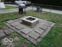 Backyard patio featuring a stone fire pit, perfect for outdoor gatherings at 121 Lake Hart, Mooresville, IN 46158