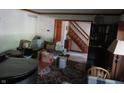 View of living room that features a staircase, wood trim, piano, and hardwood floors at 1327 Goldfinch Dr, Carmel, IN 46032