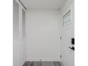 Bright entryway featuring a closet, front door with glass, and new vinyl flooring at 1537 Mutz Dr, Indianapolis, IN 46229