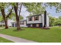 Split-level home on a large lot with mature trees and a well-maintained lawn at 1537 Mutz Dr, Indianapolis, IN 46229
