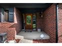 Close-up of a beautiful wooden front door and brick exterior with decorative trim at 180 Wellington Pkwy, Noblesville, IN 46060