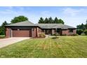 Charming single story brick home with an attached garage and lush green front lawn at 180 Wellington Pkwy, Noblesville, IN 46060