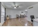 View of the living room with hardwood flooring and a dining space featuring a wooden table at 1924 W 65Th Pl, Indianapolis, IN 46260