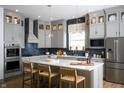 Bright, open kitchen with stainless steel appliances, a large island, and modern cabinetry at 19796 Chatham Shore Ln, Westfield, IN 46074