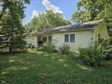 View of the front exterior with a well-maintained lawn and inviting blue front door at 2024 E 41St St, Anderson, IN 46013