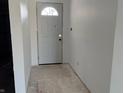 Bright entryway featuring a white door with half-moon window and neutral walls ready for personalization at 2071 S Friendship Dr, Paragon, IN 46166