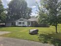 Beautiful home with well-maintained lawn, mature trees, and classic brick and siding facade at 308 N Edgeway Dr, Alexandria, IN 46001