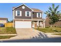 Charming two-story home with a well-maintained lawn and inviting curb appeal at 341 Thistlewood Dr, Greenfield, IN 46140