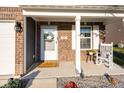 Inviting front porch with rocking chair, charming decor, and a welcoming entrance at 341 Thistlewood Dr, Greenfield, IN 46140