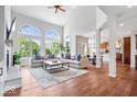 Bright living room featuring soaring ceilings, large windows, fireplace, and hardwood floors at 3711 Pete Dye Blvd, Carmel, IN 46033