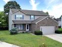 Charming two-story home with brick and siding, plus a well-kept lawn and landscaping at 3903 Junco Cir, Indianapolis, IN 46228