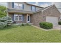 Charming home featuring brick accents, a well-manicured lawn, and blue shutters at 3903 Junco Cir, Indianapolis, IN 46228