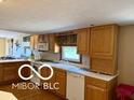 Traditional kitchen featuring light wood cabinets, a microwave, and tile backsplash at 4680 Cartersburg Rd, Plainfield, IN 46168