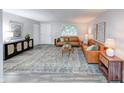 Open living room with neutral walls, modern decor, a stylish rug, and hardwood-style flooring at 5512 Lunsford Dr, Indianapolis, IN 46237