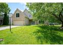 Charming brick two-story home with well-maintained lawn, blue front door and two car garage at 5640 Dapple Ct, Indianapolis, IN 46228