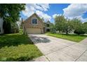 Charming brick two-story home with a well-maintained lawn and a concrete driveway at 5640 Dapple Ct, Indianapolis, IN 46228