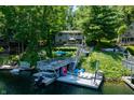 Waterfront property featuring boat dock, multiple decks, and wooded surroundings at 6254 Grosbeak Ct, Nineveh, IN 46164