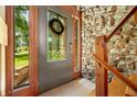 Inviting front entrance features stained glass door, stone wall, and wood trim at 6254 Grosbeak Ct, Nineveh, IN 46164