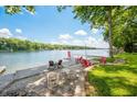 Waterfront backyard with chairs, dock, and lake access, perfect for relaxing and enjoying lake activities at 6300 Grouse Dr, Nineveh, IN 46164