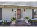 Charming front entrance with brick steps, decorative potted plants, and stylish exterior lighting at 12602 Lockerbie Cir, Carmel, IN 46033