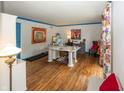 Well-lit home office with hardwood floors, artistic decor, and functional workspace at 12602 Lockerbie Cir, Carmel, IN 46033