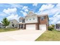 Two story home with brick and gray siding and a two-car garage, with plenty of space for parking at 1266 Hamilton Dr, Greenwood, IN 46143