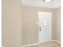 A bright foyer with a white front door and neutral-toned walls provides a welcoming entrance at 14373 Orange Blossom Trl, Fishers, IN 46038