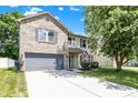 Charming two-story house featuring a well-manicured lawn and a gray two-car garage at 14373 Orange Blossom Trl, Fishers, IN 46038