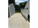 Long concrete driveway between two properties, leading to a fenced backyard at 2907 Baltimore Ave, Indianapolis, IN 46218