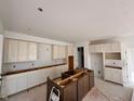 Bright kitchen featuring ample cabinets and large island ready for countertops at 3110 Montgomery Blvd, Lapel, IN 46051