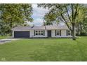 Charming single-story home with a well-manicured lawn at 3120 S Meridian Rd, Greenfield, IN 46140