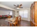 Comfortable dining room with hardwood floors and open view into the living area with a large brown sofa at 3624 Newberry Rd, Plainfield, IN 46168