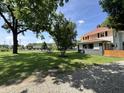 Home has lush lawn and mature trees with nice landscaping at 4106 N Sherman Dr, Indianapolis, IN 46226
