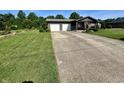 Well-manicured lawn and long driveway leading to a single story home with a two-car garage at 474 N Kristi Rd, Martinsville, IN 46151