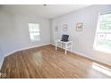 Spacious room with lots of sunlight, wood-look floors, and neutral walls at 5652 Apple Branch Way, Indianapolis, IN 46237