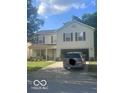 Charming two-story home with a two-car garage and a well-manicured front yard at 6548 Frankenberger Dr, Indianapolis, IN 46237