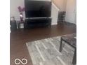 This living room features modern floors, a television, and a neutral color scheme at 6548 Frankenberger Dr, Indianapolis, IN 46237