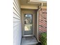 Close up of the home's front door, showcasing the glass screen door and brick and siding at 7259 Registry Dr, Indianapolis, IN 46217