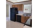 Kitchen with modern appliances and cabinets, tiled floor and view into the living space at 7259 Registry Dr, Indianapolis, IN 46217